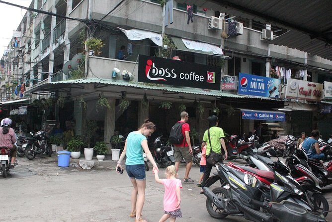 Good Morning Saigon Tour by Motorbike and Scooter - The bridge moment near District 5: modern versus poorer areas
